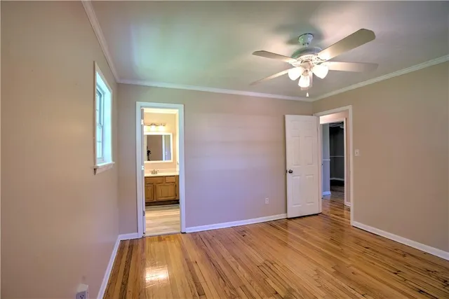 a view of a livingroom with a chandelier fan and a window