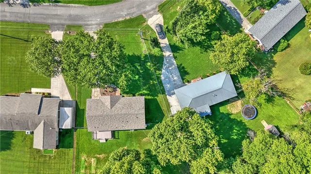 an aerial view of a house with yard and outdoor seating