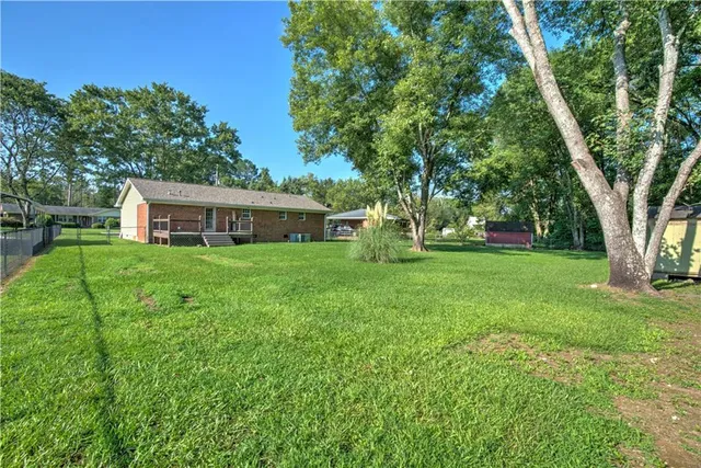 a view of a house with a yard deck and sitting area