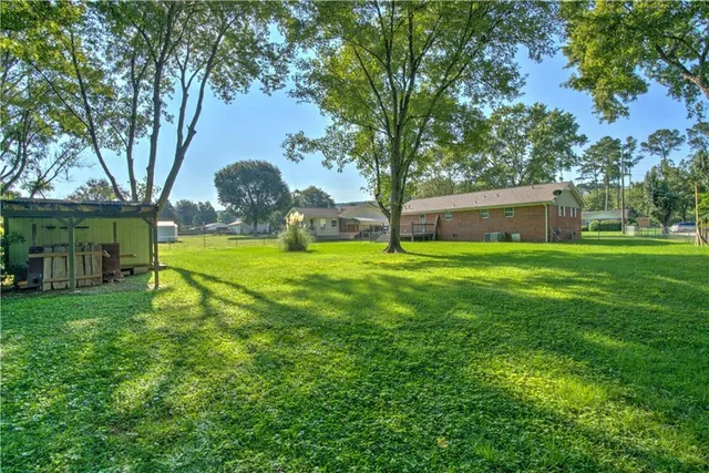 a view of a backyard with large trees