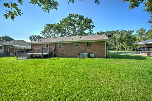 a view of house with backyard