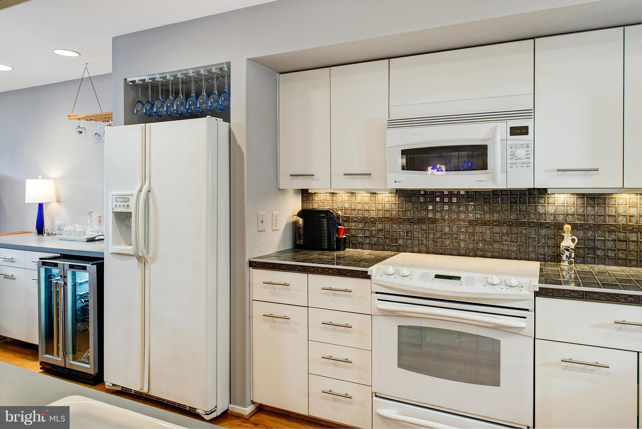 2022 Turtle Pond Drive Reston, VA 20191 - Photo 13 of 30 a kitchen with white cabinets and white appliances