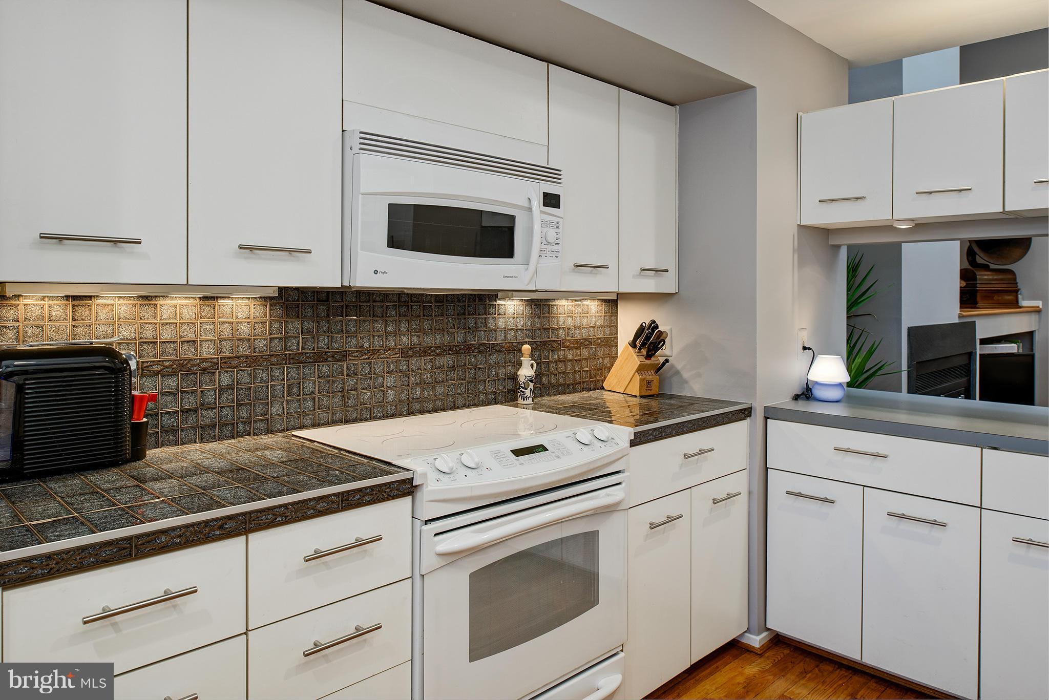 2022 Turtle Pond Drive Reston, VA 20191 - Photo 15 of 30 a kitchen with white cabinets and white appliances