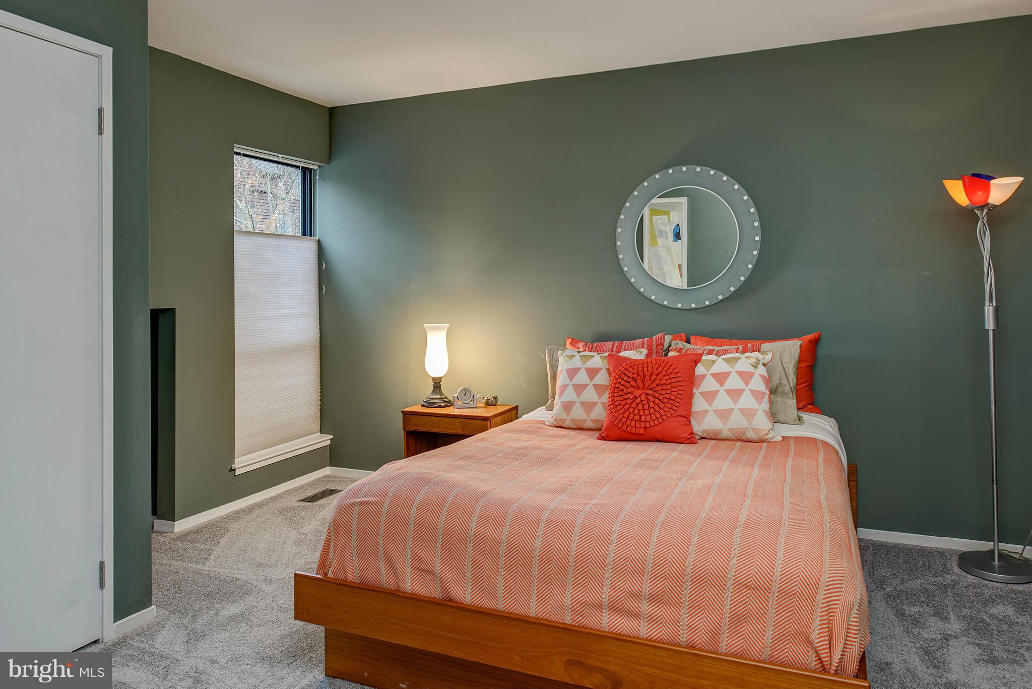 2022 Turtle Pond Drive Reston, VA 20191 - Photo 24 of 30 a bedroom with a bed and a chandelier