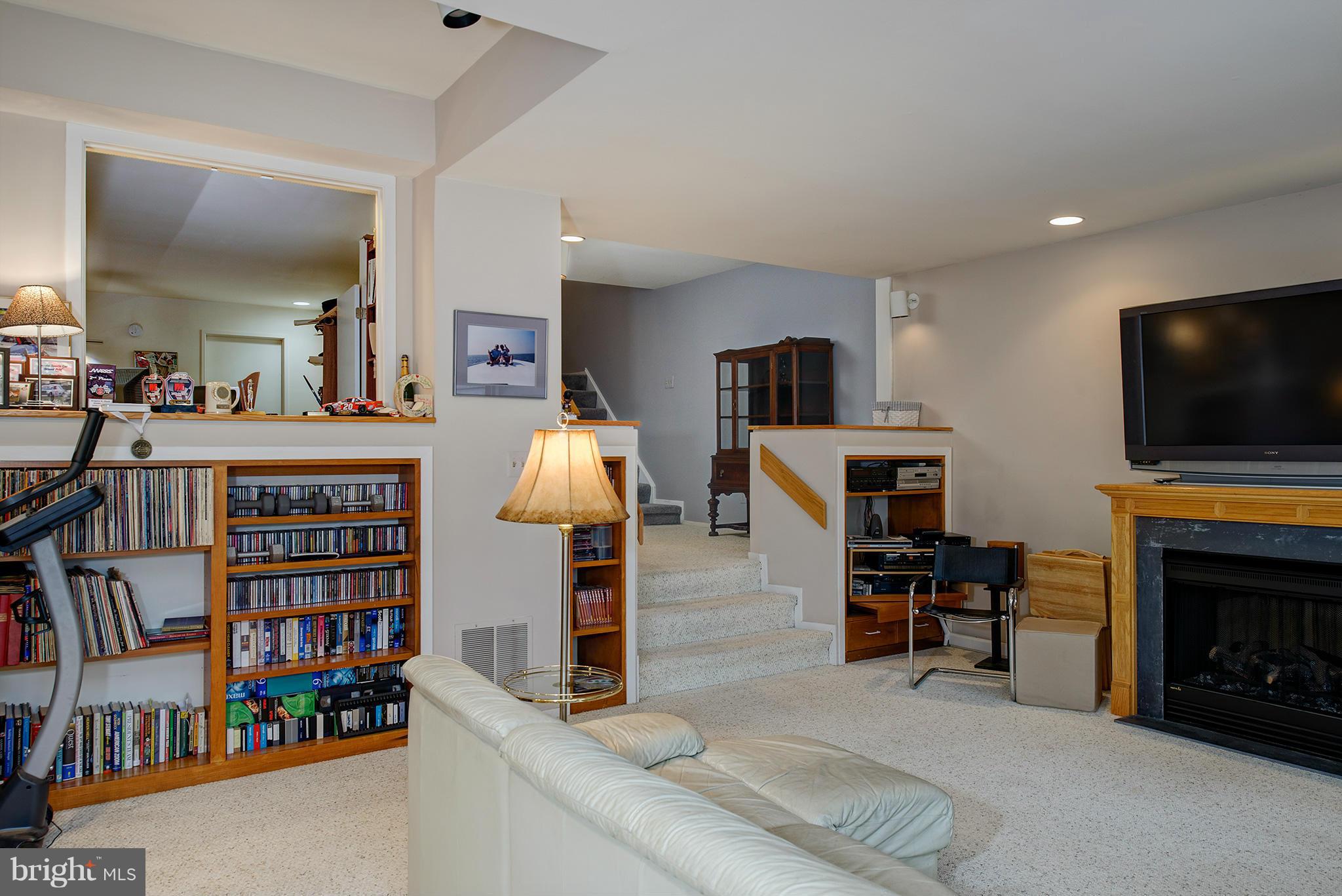 2022 Turtle Pond Drive Reston, VA 20191 - Photo 26 of 30 a living room with fireplace furniture and a flat screen tv