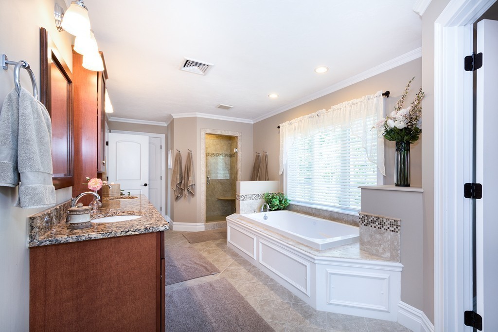 17 Evangeline Drive Scituate, MA 02066 - Photo 16 of 27 a spacious bathroom with a granite countertop tub and a large mirror