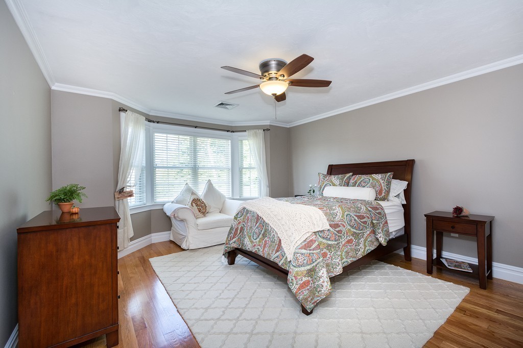 17 Evangeline Drive Scituate, MA 02066 - Photo 17 of 27 a bedroom with a bed and a chandelier