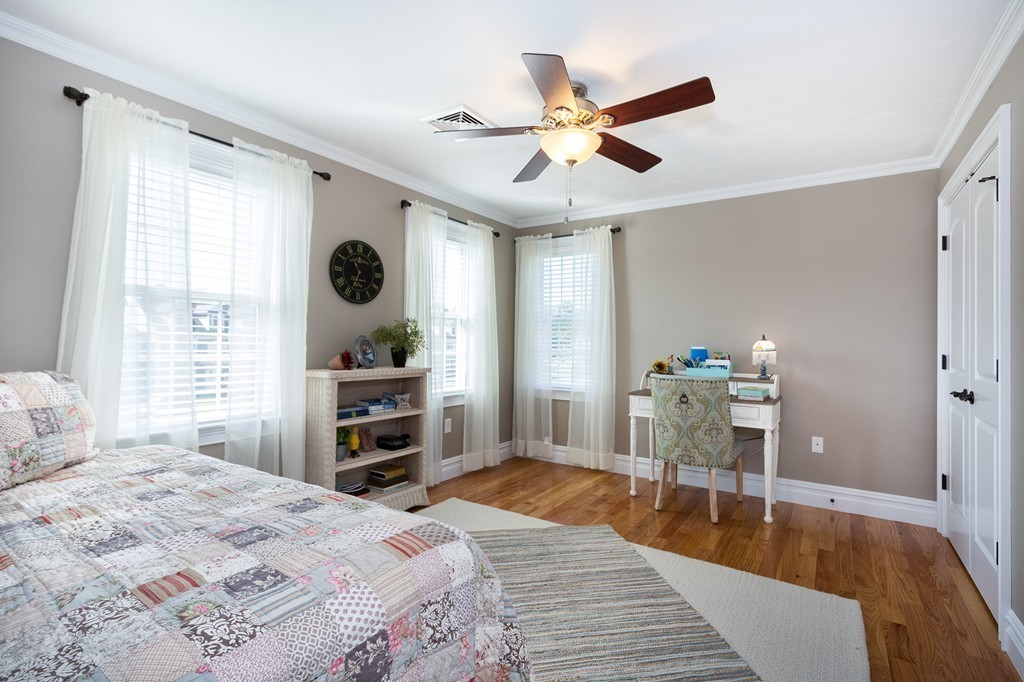 17 Evangeline Drive Scituate, MA 02066 - Photo 18 of 27 a bedroom with a bed and a chandelier