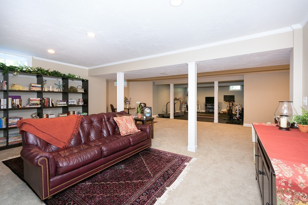 17 Evangeline Drive Scituate, MA 02066 - Photo 22 of 27 a living room with furniture a rug and a table