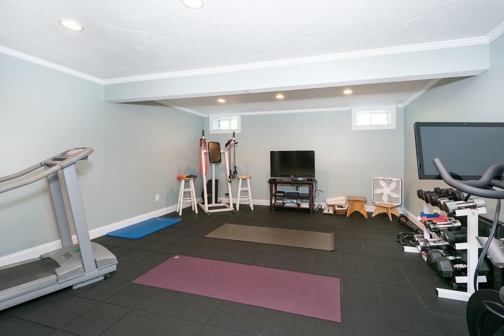 17 Evangeline Drive Scituate, MA 02066 - Photo 24 of 27 a living room with furniture a flat screen tv and a window