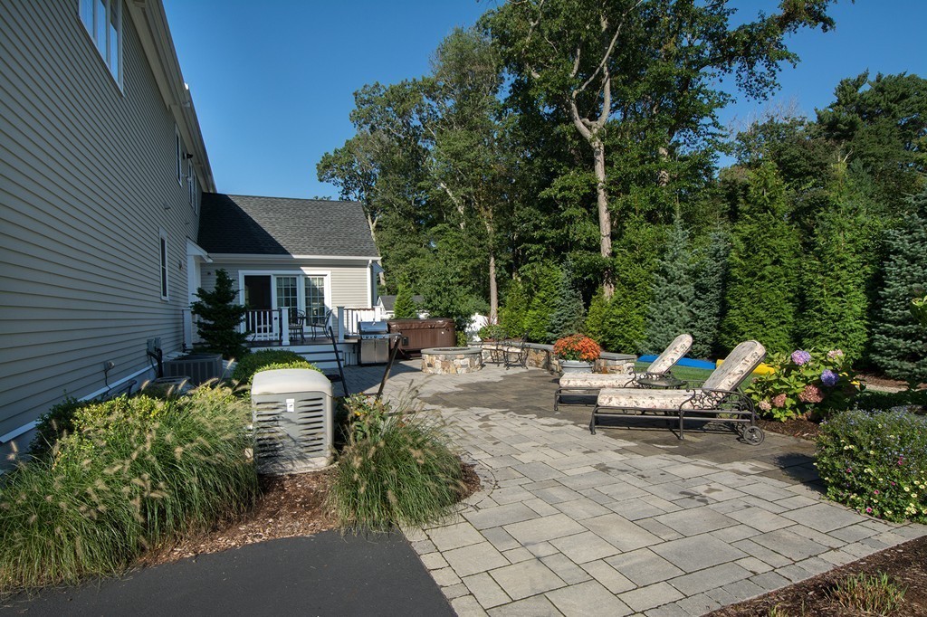 17 Evangeline Drive Scituate, MA 02066 - Photo 27 of 27 a view of a patio with couches and table and chairs with wooden fence and plants