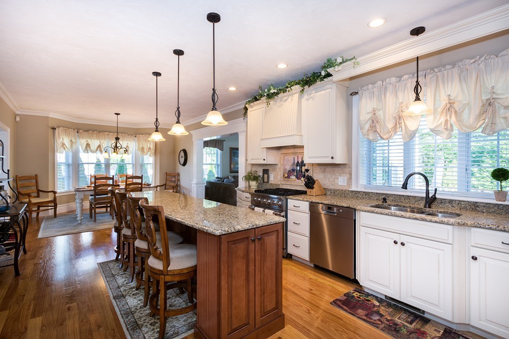 17 Evangeline Drive Scituate, MA 02066 - Photo 5 of 27 a kitchen with stainless steel appliances granite countertop a stove a sink dishwasher and a wooden cabinets