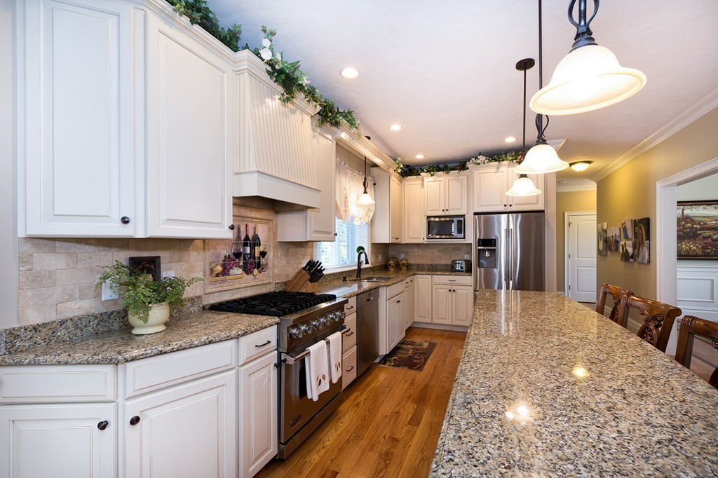 17 Evangeline Drive Scituate, MA 02066 - Photo 7 of 27 a kitchen with granite countertop a stove a sink a refrigerator and window