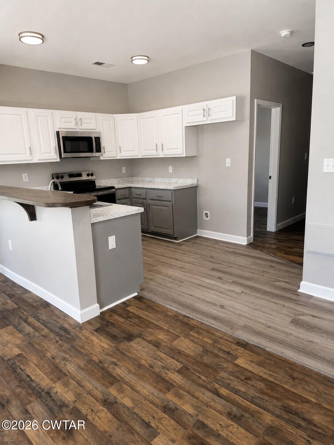 103 Dempster Street Jackson, TN 38301 - Photo 12 of 18 a kitchen with stainless steel appliances granite countertop a stove a sink and a refrigerator