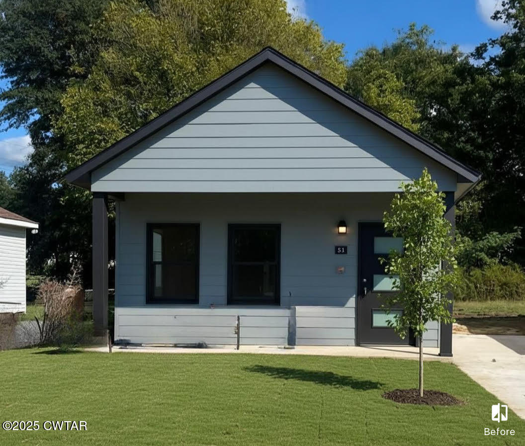 103 Dempster Street Jackson, TN 38301 - Photo 2 of 2 a front view of a house with a yard