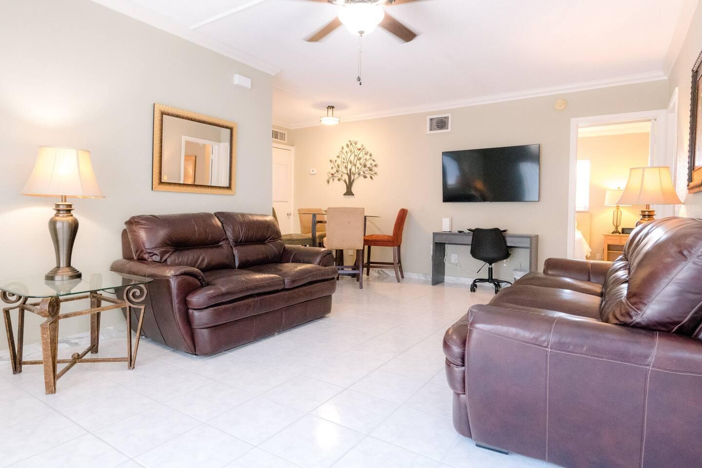 Undisclosed Address Pompano Beach, FL 33062 - Photo 11 of 16 a living room with furniture a flat screen tv and a window