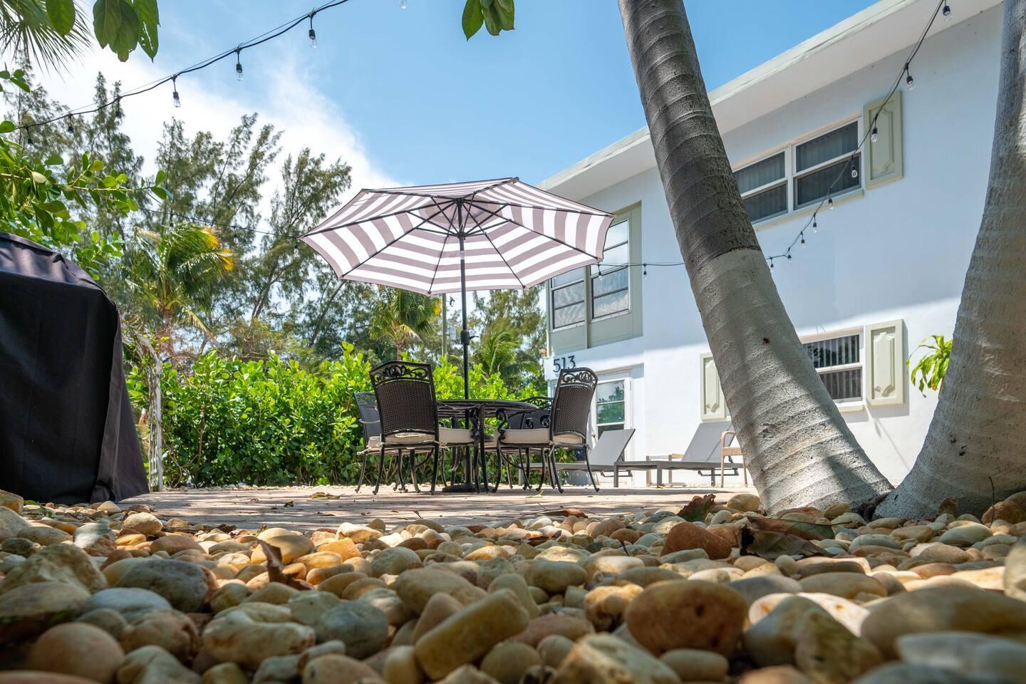 Undisclosed Address Pompano Beach, FL 33062 - Photo 4 of 16 a view of a backyard with table and chairs under an umbrella