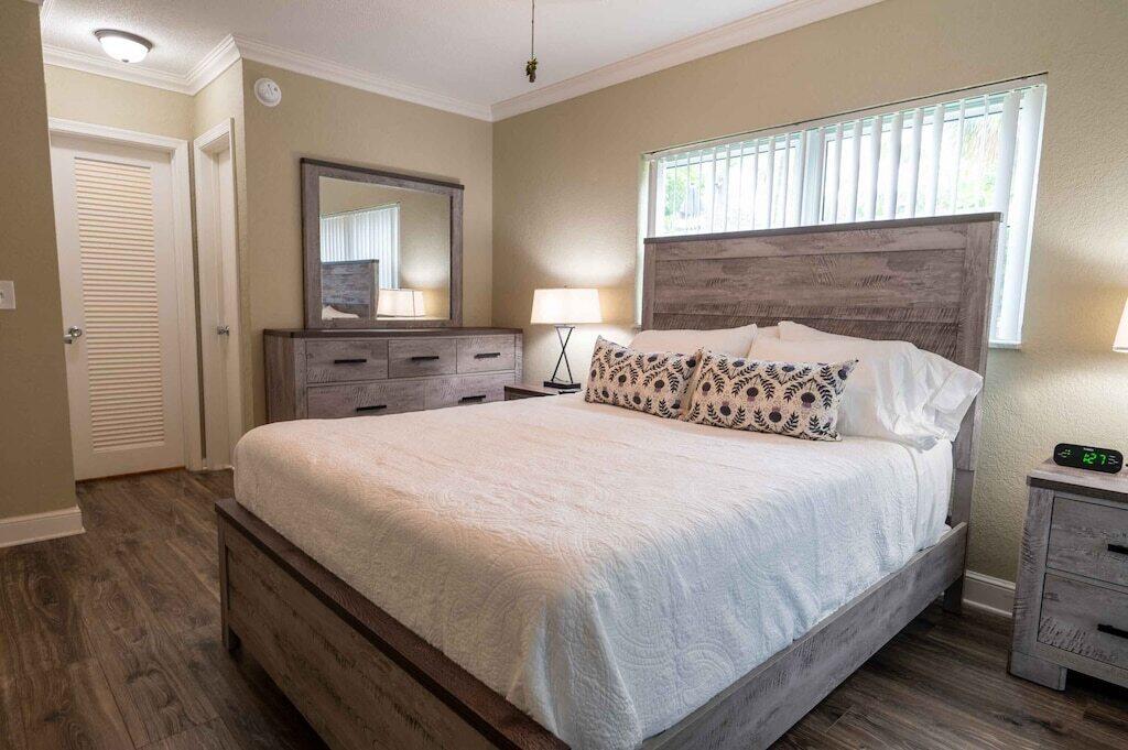 Undisclosed Address Pompano Beach, FL 33062 - Photo 5 of 16 a bedroom with a bed and a mirror