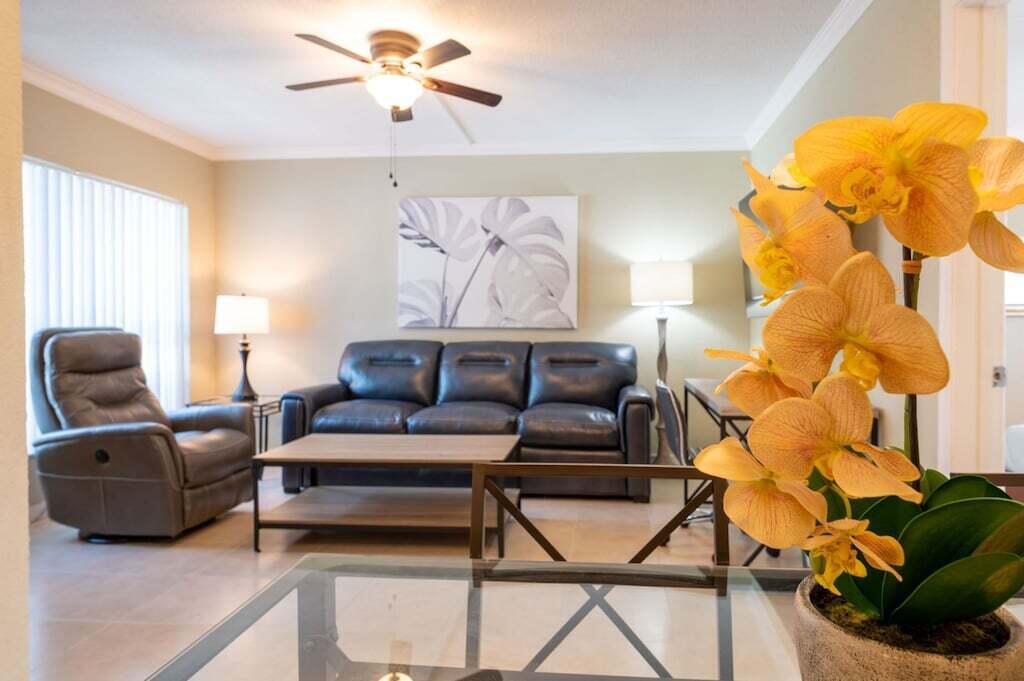 Undisclosed Address Pompano Beach, FL 33062 - Photo 6 of 16 a living room with a couch and a chandelier