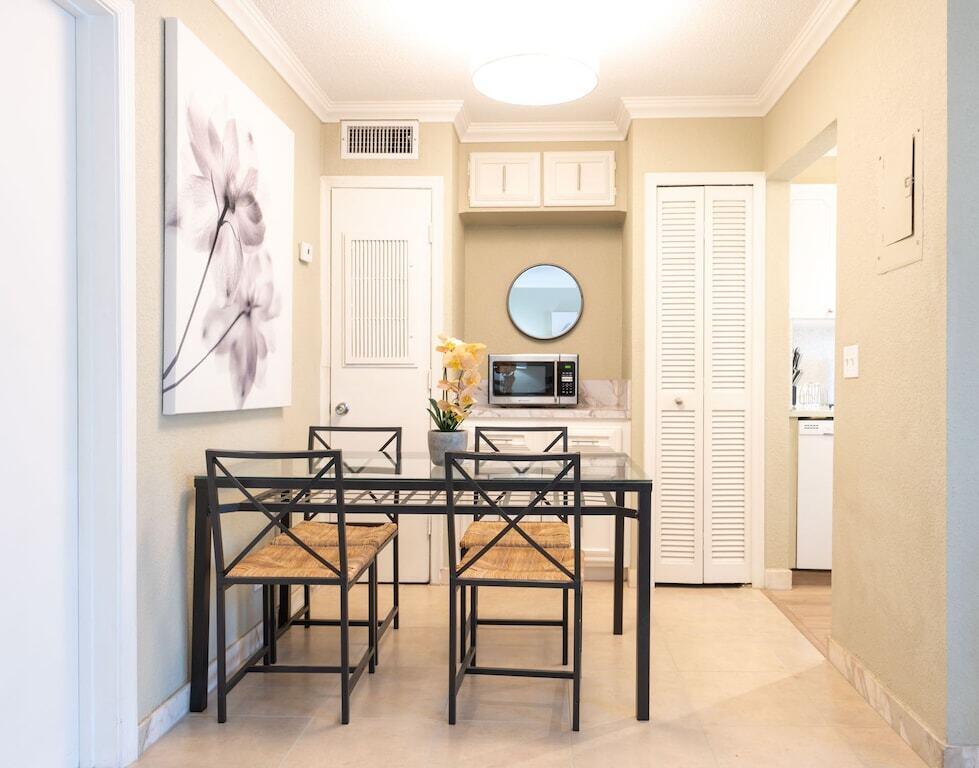 Undisclosed Address Pompano Beach, FL 33062 - Photo 7 of 16 a view of a room with chairs and a table