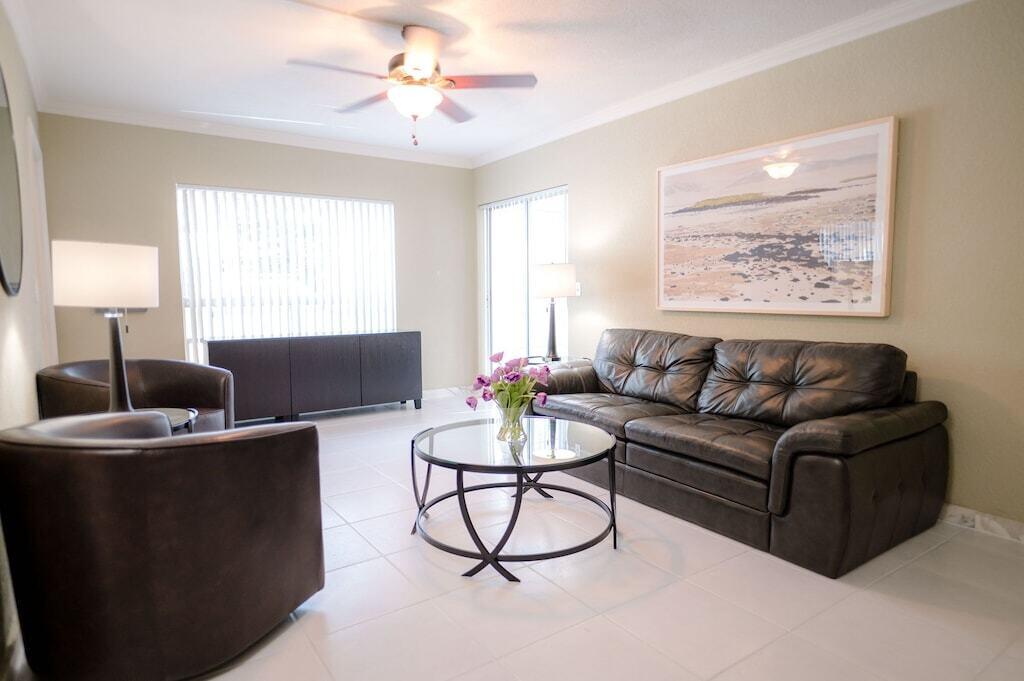 Undisclosed Address Pompano Beach, FL 33062 - Photo 9 of 16 a living room with furniture a window and a lamp