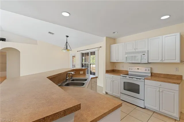 a kitchen with cabinets and white appliances