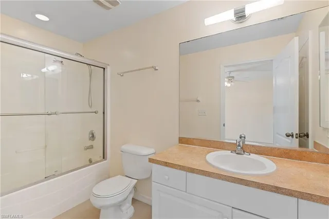 a bathroom with a sink toilet vanity and shower