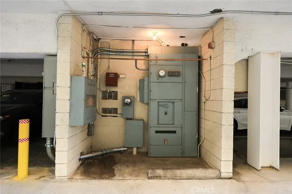 an empty room with wooden floor chandelier fan and windows