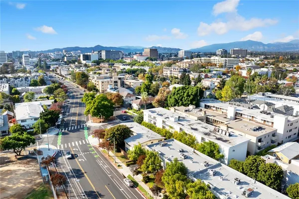 a kitchen with a refrigerator sink and white cabinets