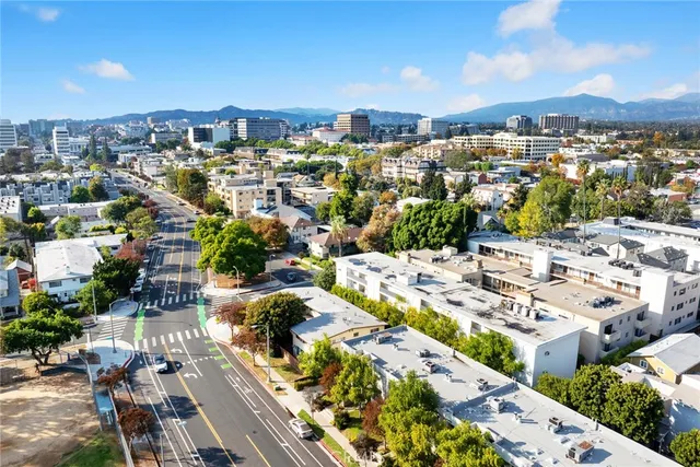 a kitchen with a refrigerator sink and white cabinets