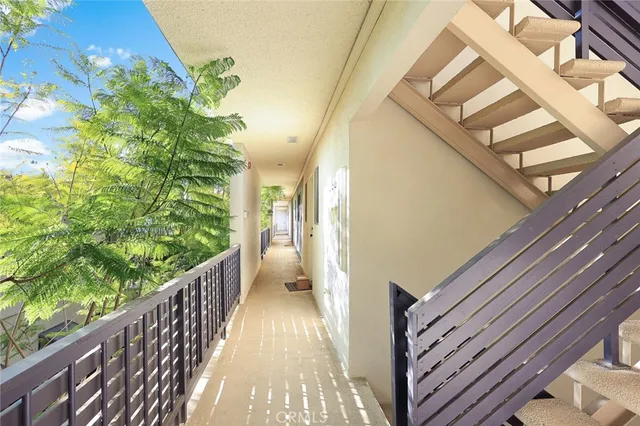 a view of a hallway with wooden floor and fence