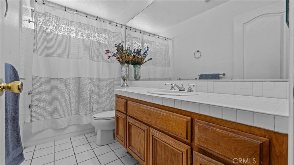 1671 Dominguez Ranch Road Corona, CA 92878 - Photo 24 of 42 This secondary bathroom includes a large vanity, tiled flooring, and a shower-tub combination, designed for everyday convenience.