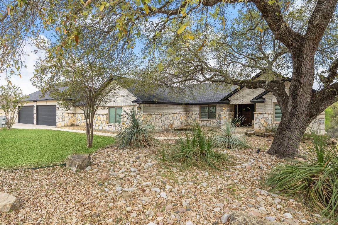 515 Wesley Ridge Drive Spicewood, TX 78669 - Photo 1 of 36 a view of a house with a yard