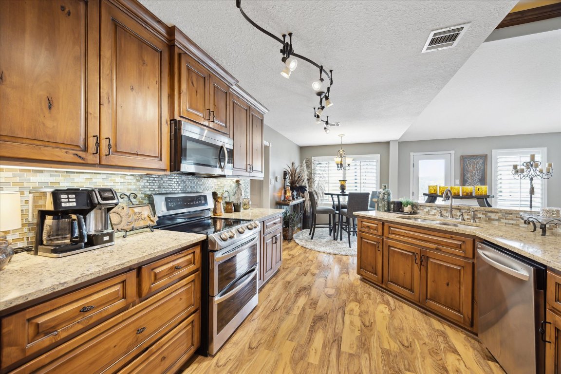 515 Wesley Ridge Drive Spicewood, TX 78669 - Photo 11 of 36 a kitchen with lots of counter top space and appliances