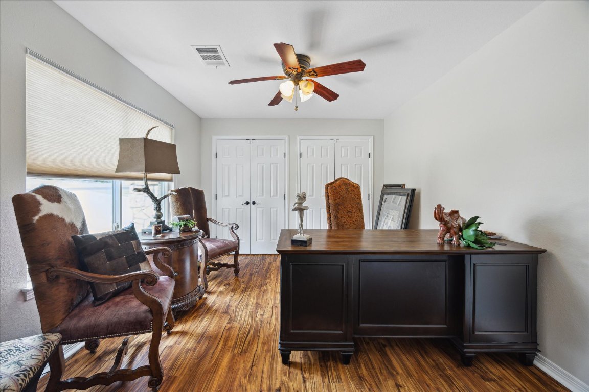 515 Wesley Ridge Drive Spicewood, TX 78669 - Photo 15 of 36 a work room with furniture and wooden floor