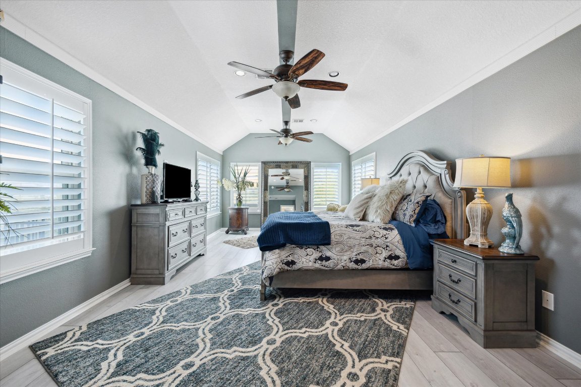 515 Wesley Ridge Drive Spicewood, TX 78669 - Photo 16 of 36 a living room with furniture a rug and a chandelier