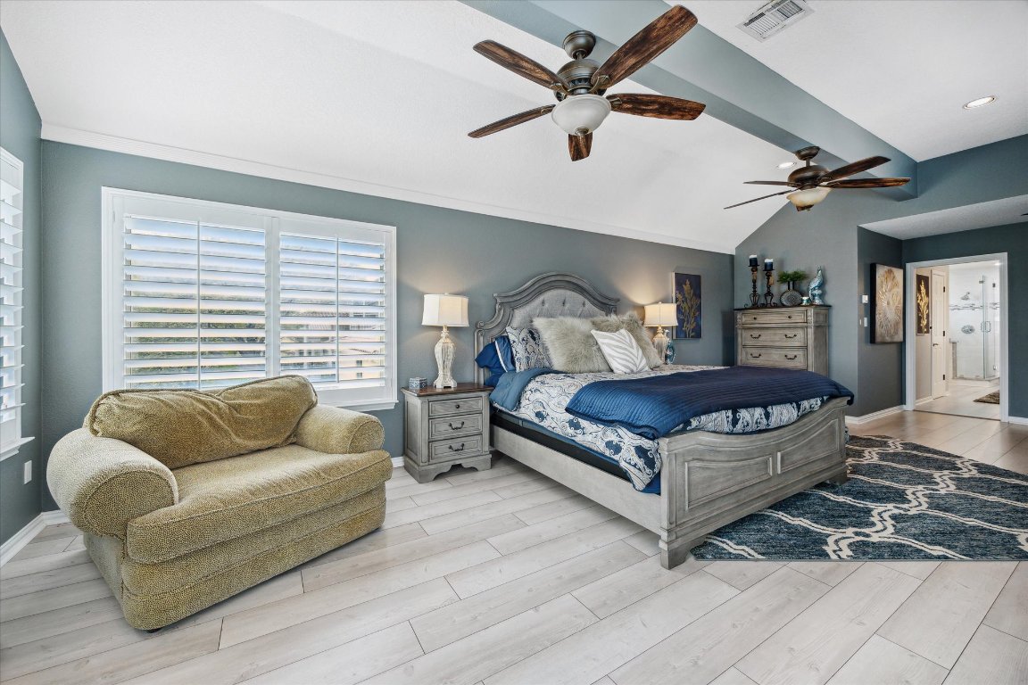 515 Wesley Ridge Drive Spicewood, TX 78669 - Photo 17 of 36 a bedroom with a large bed couch and a window