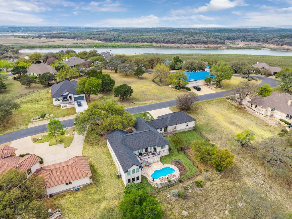 515 Wesley Ridge Drive Spicewood, TX 78669 - Photo 2 of 36 an aerial view of a house with a swimming pool yard and outdoor seating