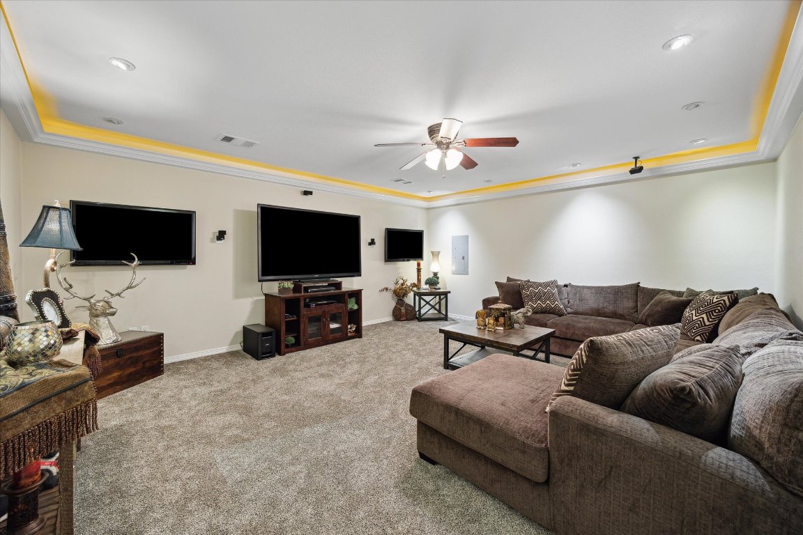 515 Wesley Ridge Drive Spicewood, TX 78669 - Photo 21 of 36 a living room with furniture and a flat screen tv