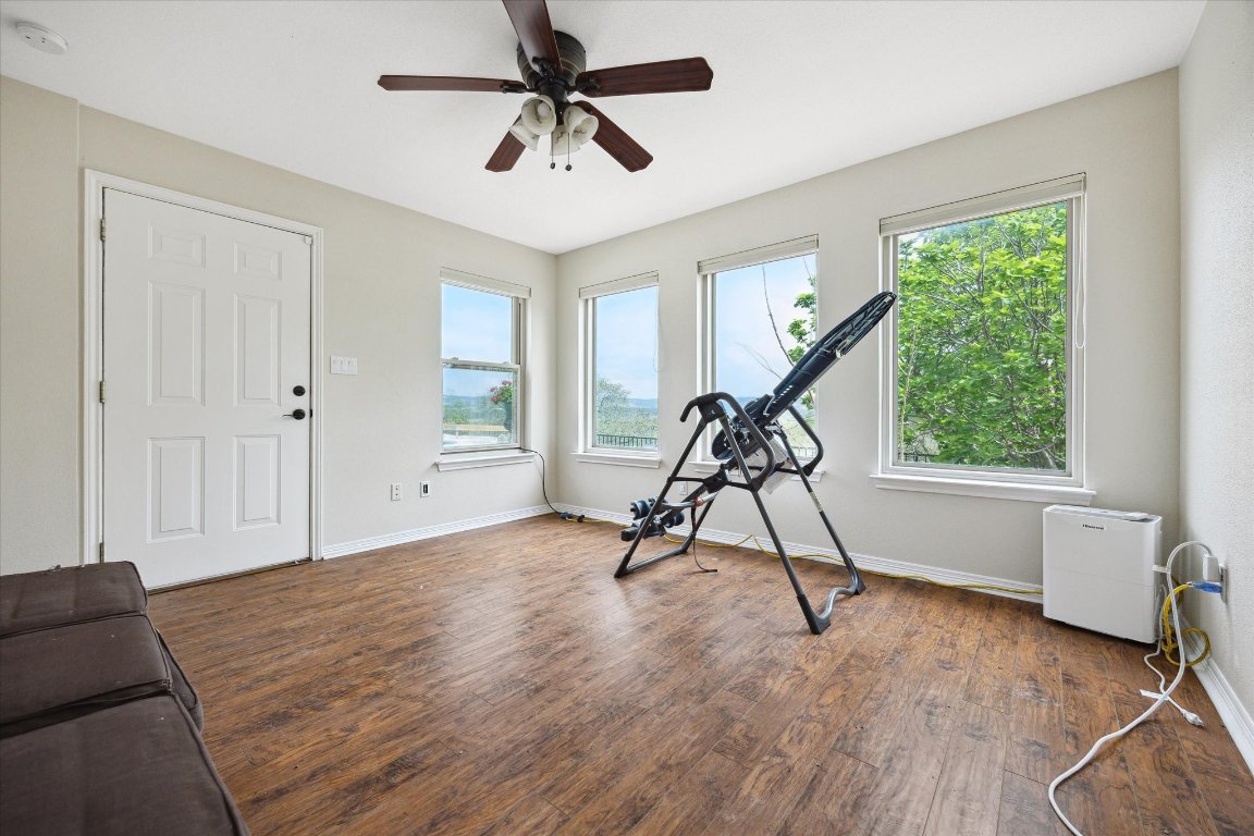 515 Wesley Ridge Drive Spicewood, TX 78669 - Photo 22 of 36 a view of a livingroom with furniture and a floor to ceiling window