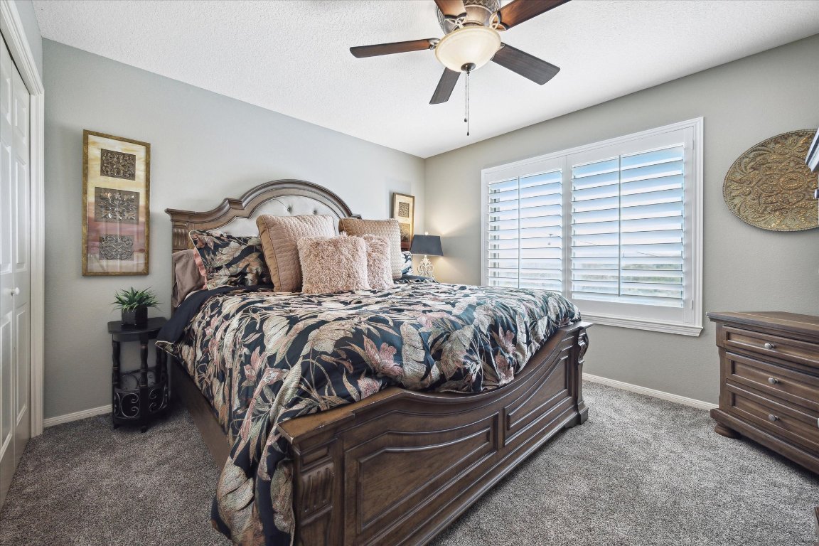 515 Wesley Ridge Drive Spicewood, TX 78669 - Photo 23 of 36 a bed sitting in a bedroom next to a window