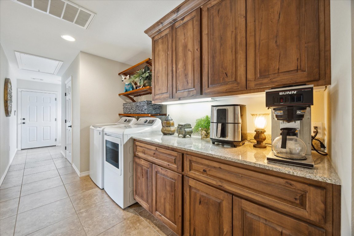 515 Wesley Ridge Drive Spicewood, TX 78669 - Photo 26 of 36 a kitchen with a sink and cabinets