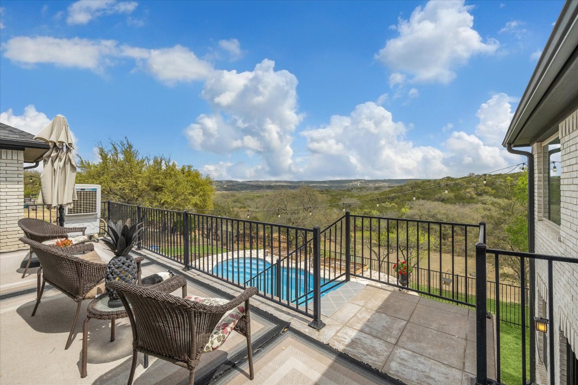 515 Wesley Ridge Drive Spicewood, TX 78669 - Photo 29 of 36 a view of a balcony with chair and wooden floor