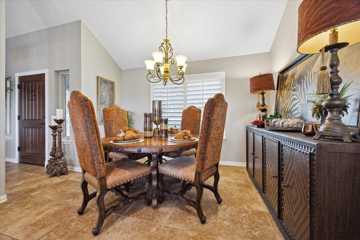515 Wesley Ridge Drive Spicewood, TX 78669 - Photo 8 of 36 a dining room with furniture a chandelier and wooden floor