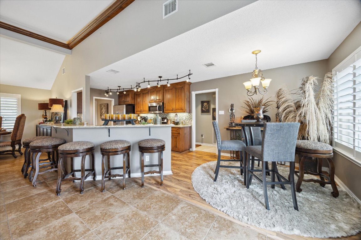515 Wesley Ridge Drive Spicewood, TX 78669 - Photo 10 of 36 a dining room with furniture and chandelier or kitchen view