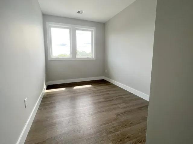 a bathroom with a granite countertop sink toilet and mirror