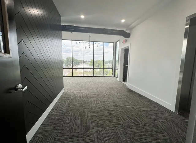 a view of a kitchen with wooden floor and electronic appliances