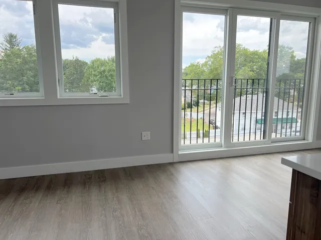 a kitchen with stainless steel appliances granite countertop a stove a sink a center island and a window