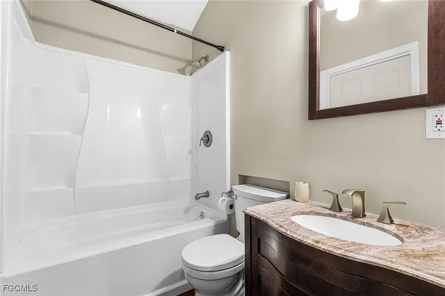 a view of a house with backyard and deck