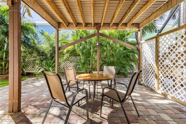 a view of a roof deck with couches and potted plants